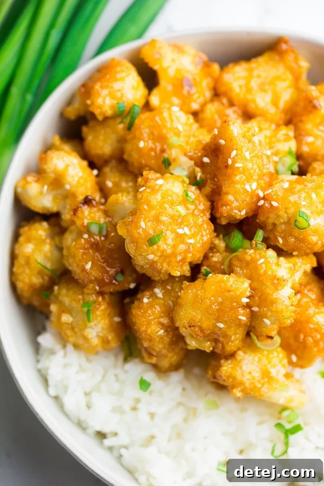 Sunset Cauliflower 2 bowl with white rice and orange cauliflower, green onions on top