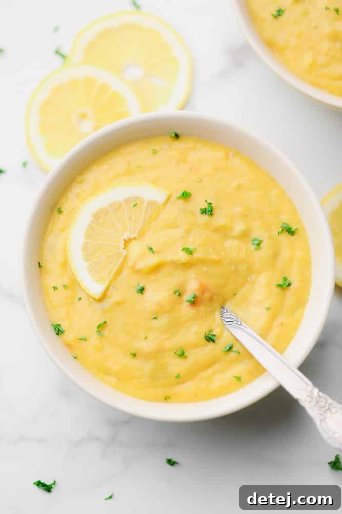 looking down on a bowl of lentil lemon soup, marble backdrop