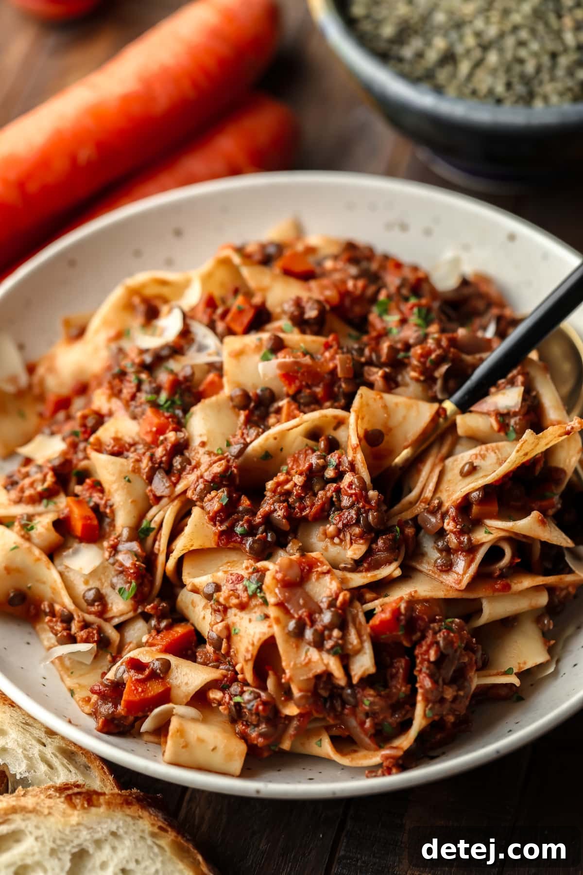speckled bowl with a fork getting some lentil pasta on it