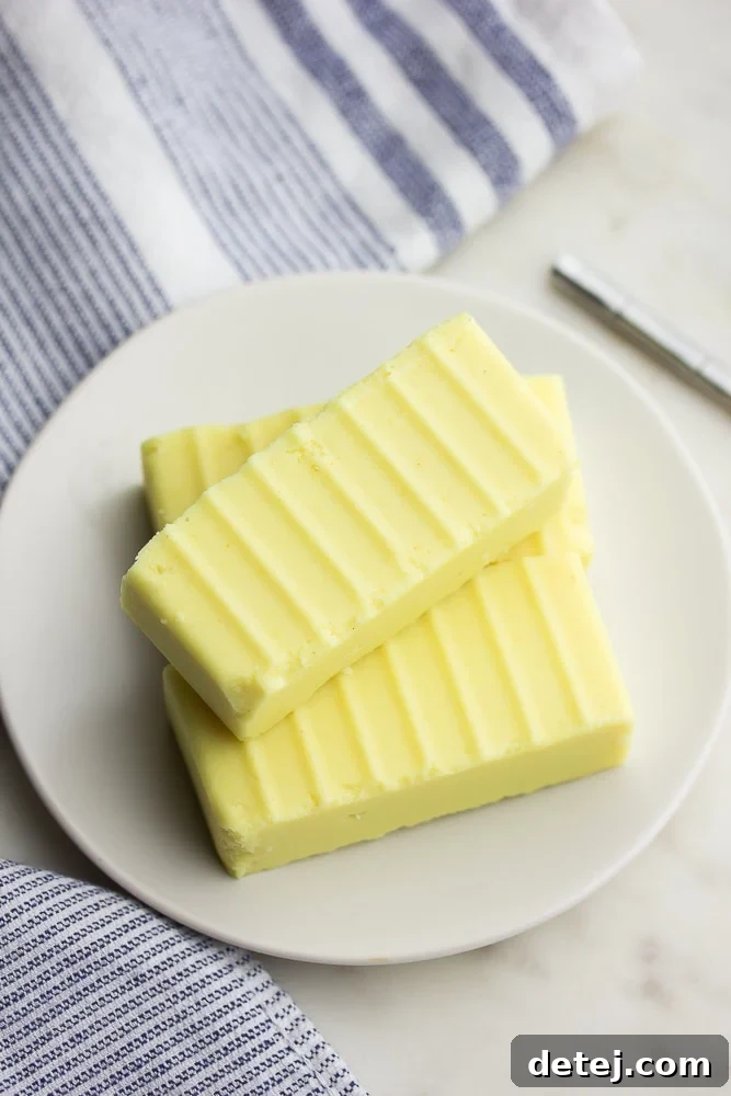 Sticks of homemade vegan butter on a white plate, viewed from above