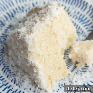 looking down on a piece of coconut cake, bite taken