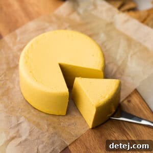 square image of a block of homemade vegan cheddar cheese