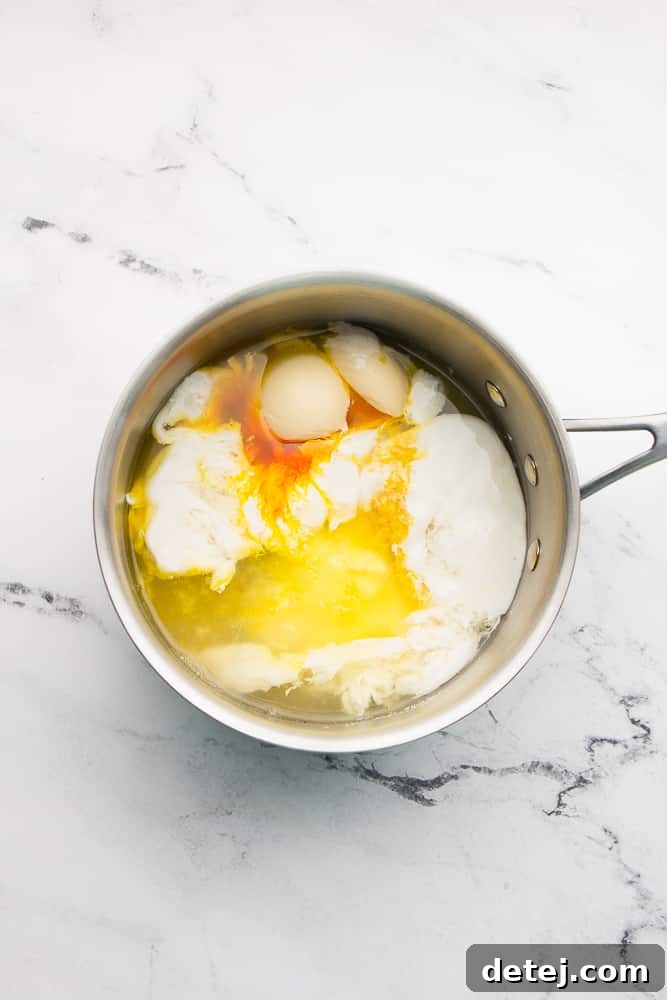 pan with ingredients like milk, lemon juice and butter, white marble background