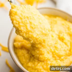 square image of cheesy mixture in a bowl with spoonful