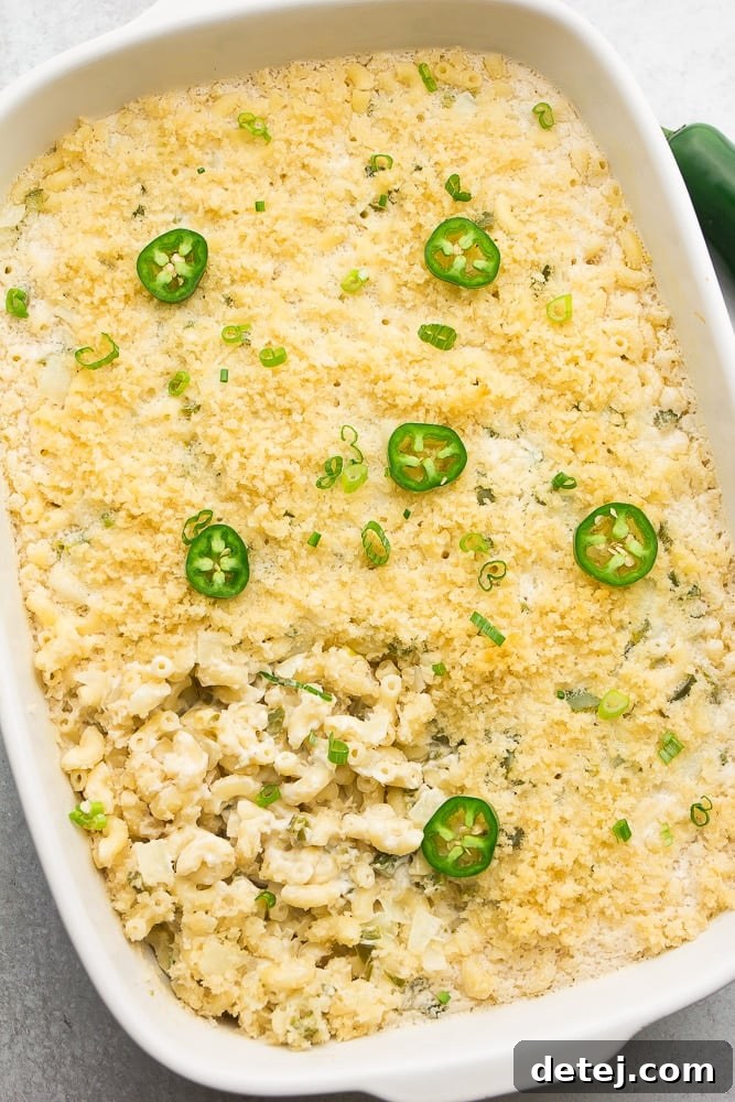 showing whole white casserole dish with baked mac and cheese with jalapenos