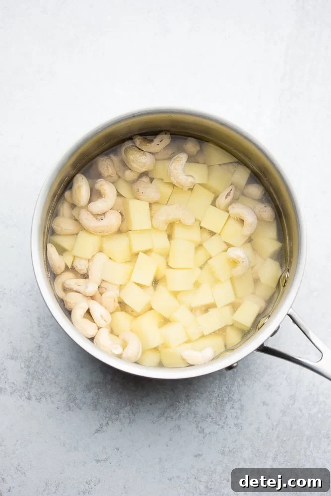 small pot full of potatoes and cashews in water