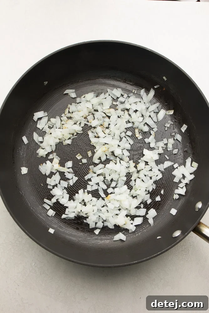 chopped onion in a pan, sautéing