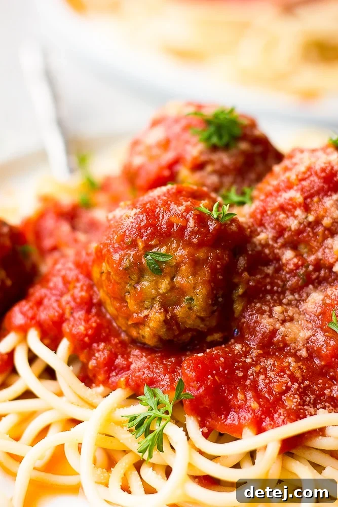 close up of a ball with marinara on spaghetti