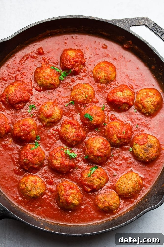 cast iron pan with meatballs in marinara