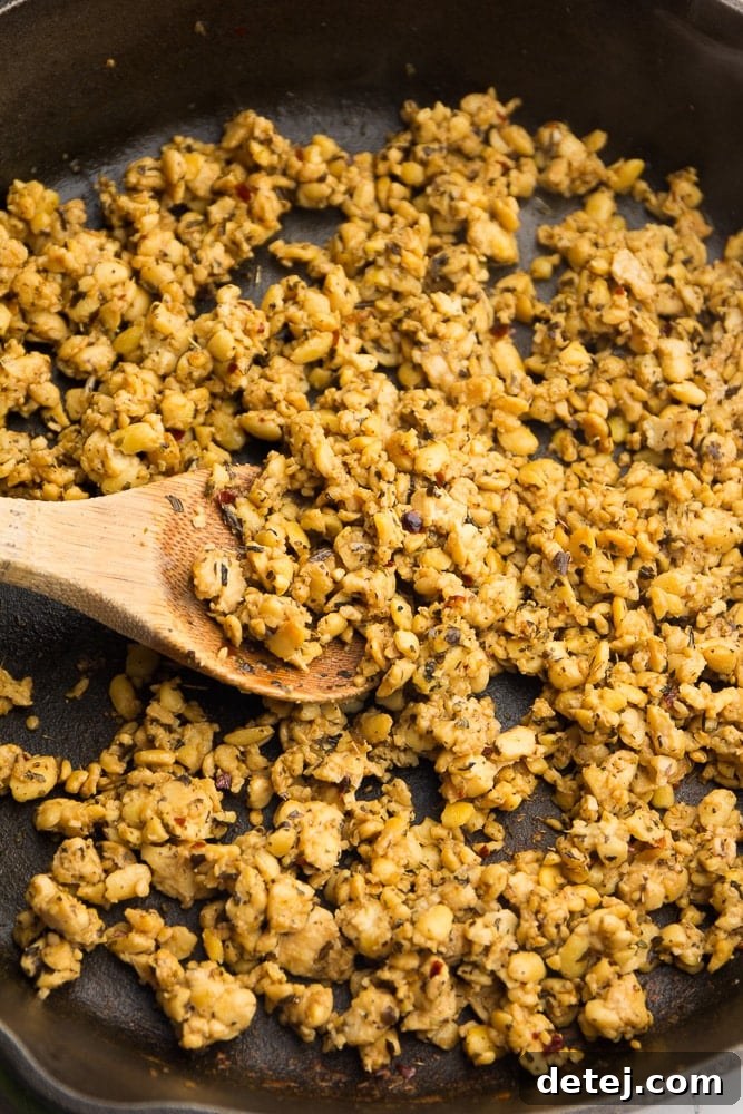 Tempeh sautéing in a cast iron skillet