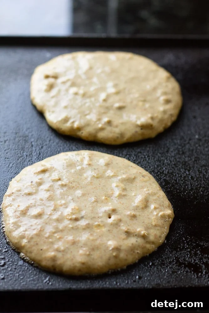 Cooking Freezer Whole Grain Pancakes on a hot griddle until bubbles appear.