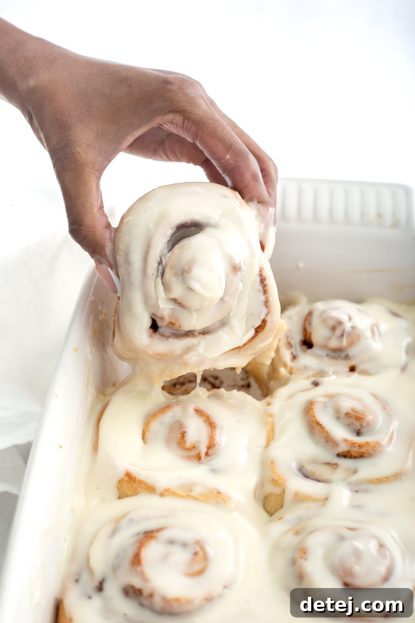 Baked golden-brown cinnamon rolls in a baking dish