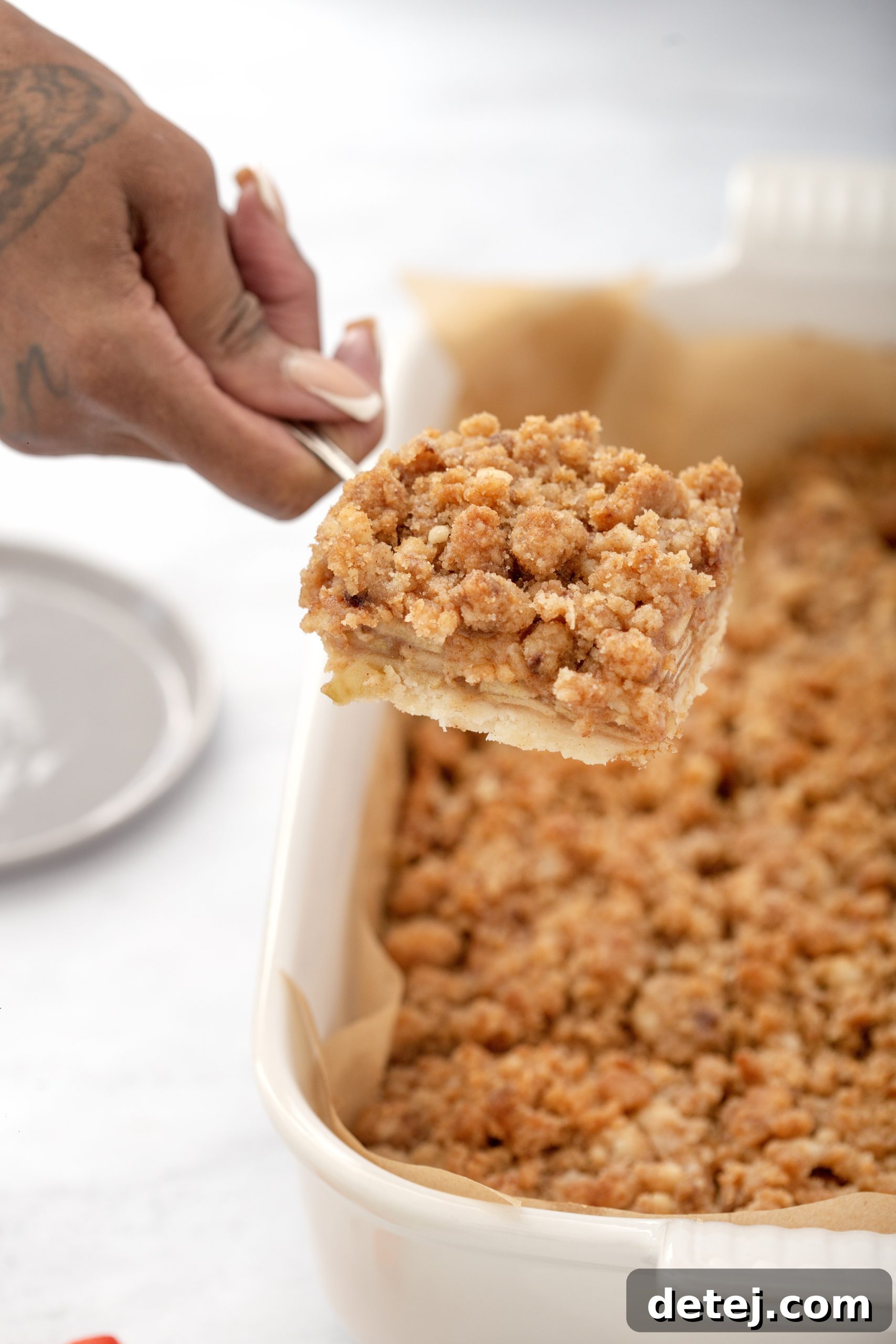 Assembling Apple Crisp Bars in a baking dish