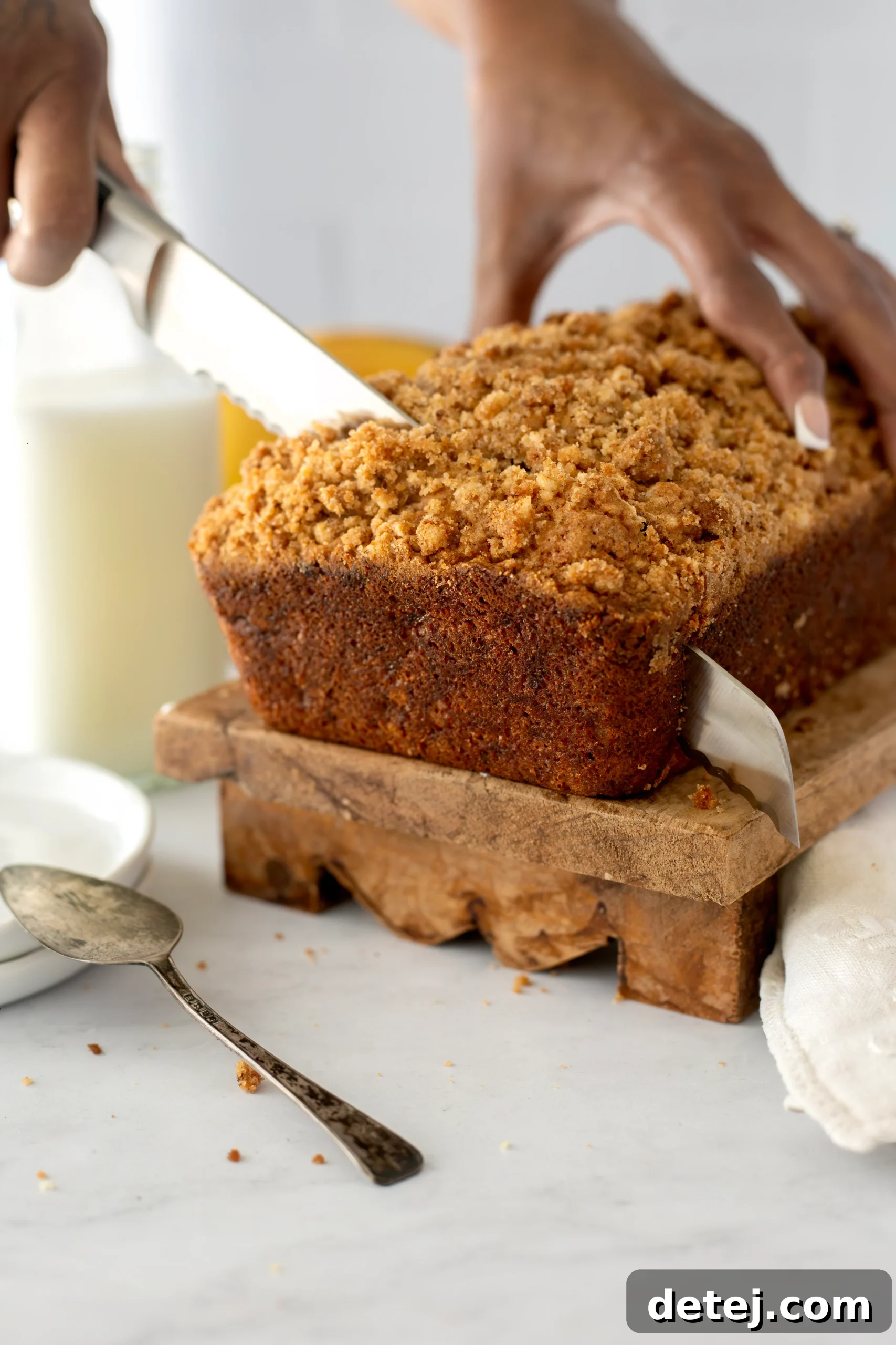 A perfectly baked loaf of moist banana bread, sliced to reveal its tender interior.