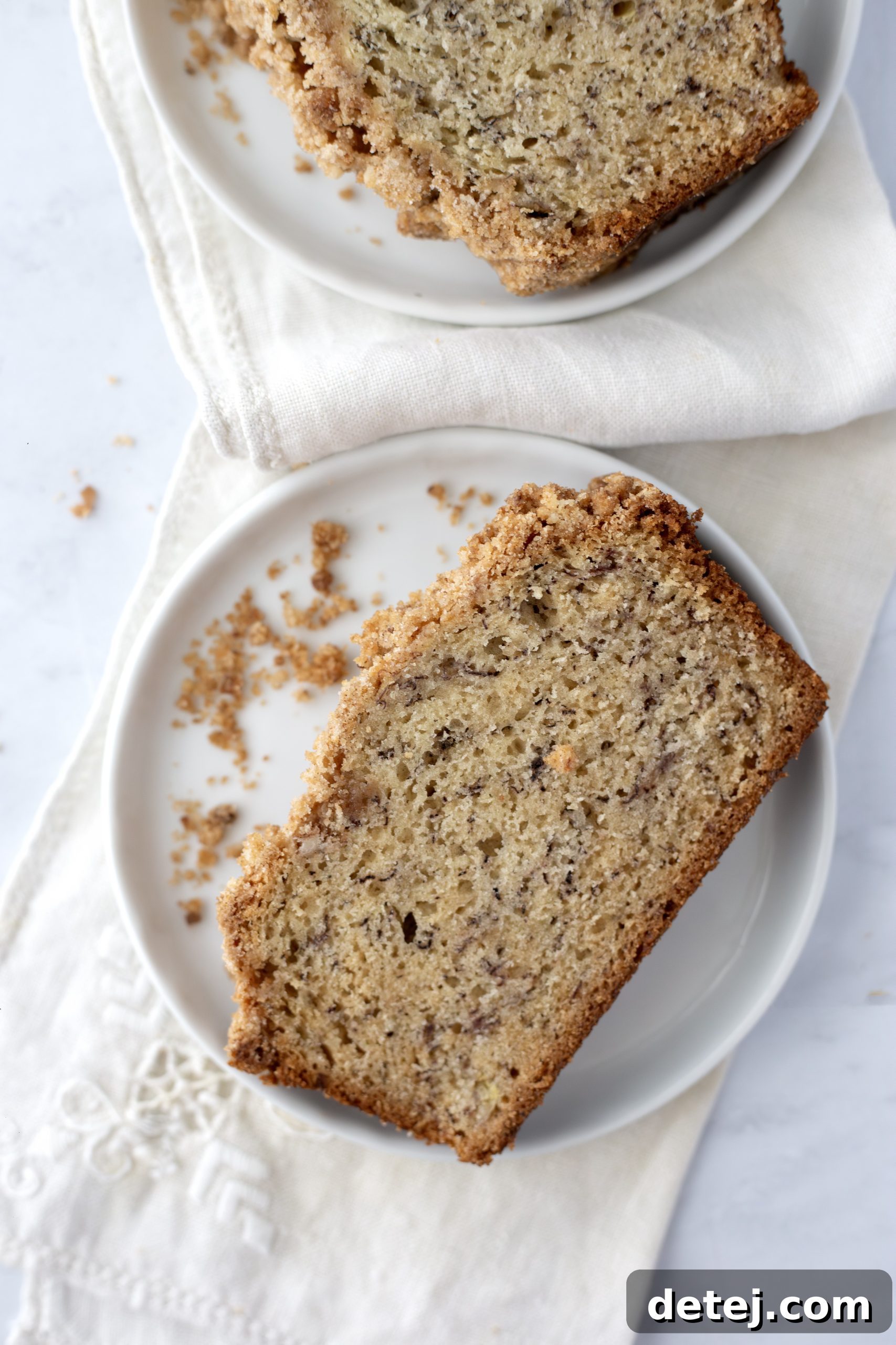 A slice of banana bread with walnuts and chocolate chips, ready to be served.