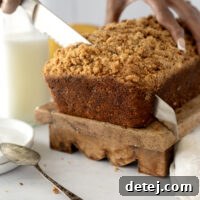 A slice of delicious banana bread with a crumb topping.