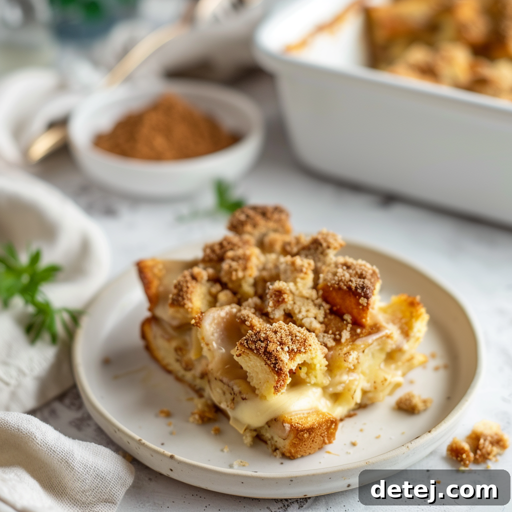 French Toast Bake with Streusel, served with maple syrup and powdered sugar.
