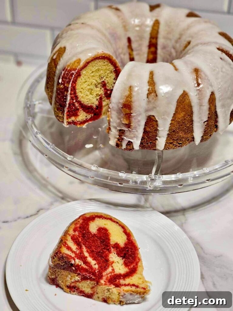 Close-up of a slice of Yellow and Red Velvet Marble Bundt Cake, revealing the intricate swirl pattern