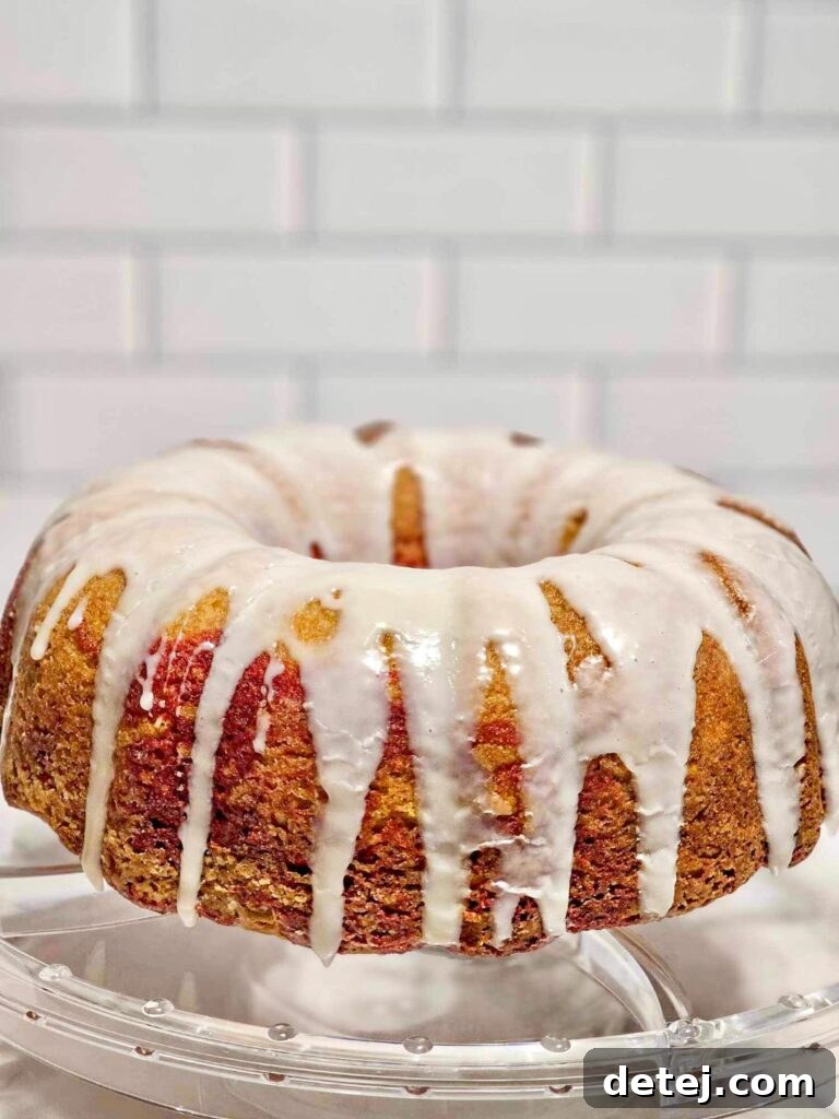 Red Velvet Marble Bundt Cake drizzled with creamy vanilla glaze, ready for serving
