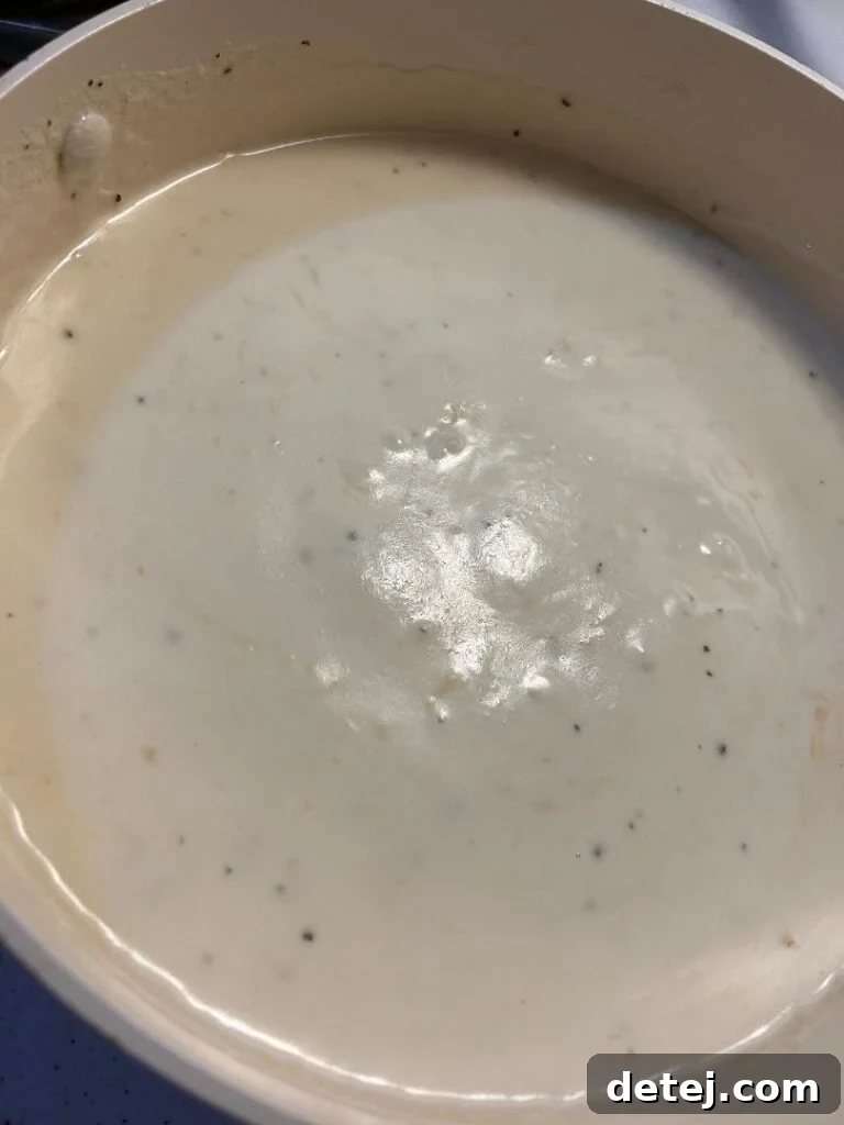 Creamy Alfredo sauce bubbling gently