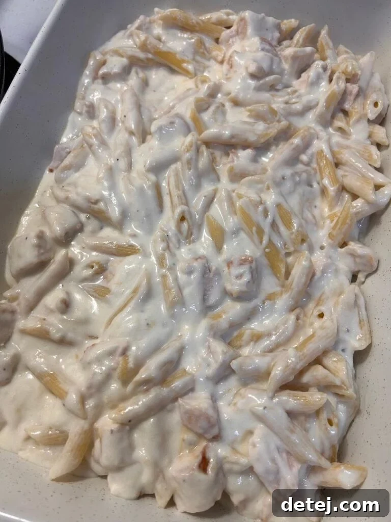 Final topping of mozzarella on Chicken Alfredo Bake