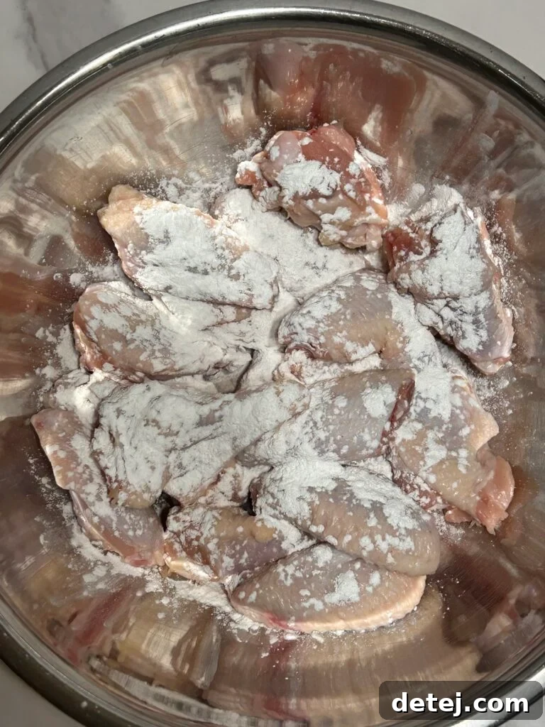 Crispy Garlic Parmesan Wings being prepared on a baking sheet.