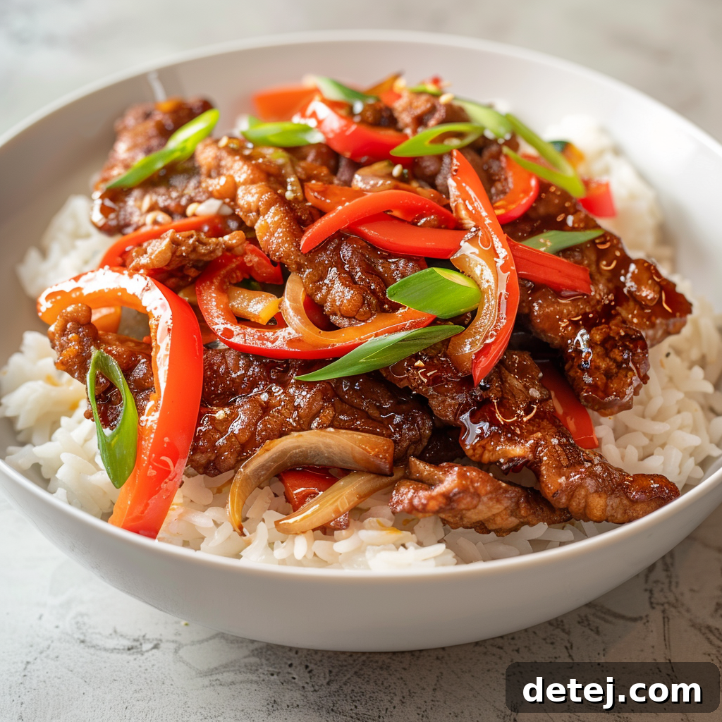 Easy Crispy Sweet Chilli Beef Recipe plated with rice