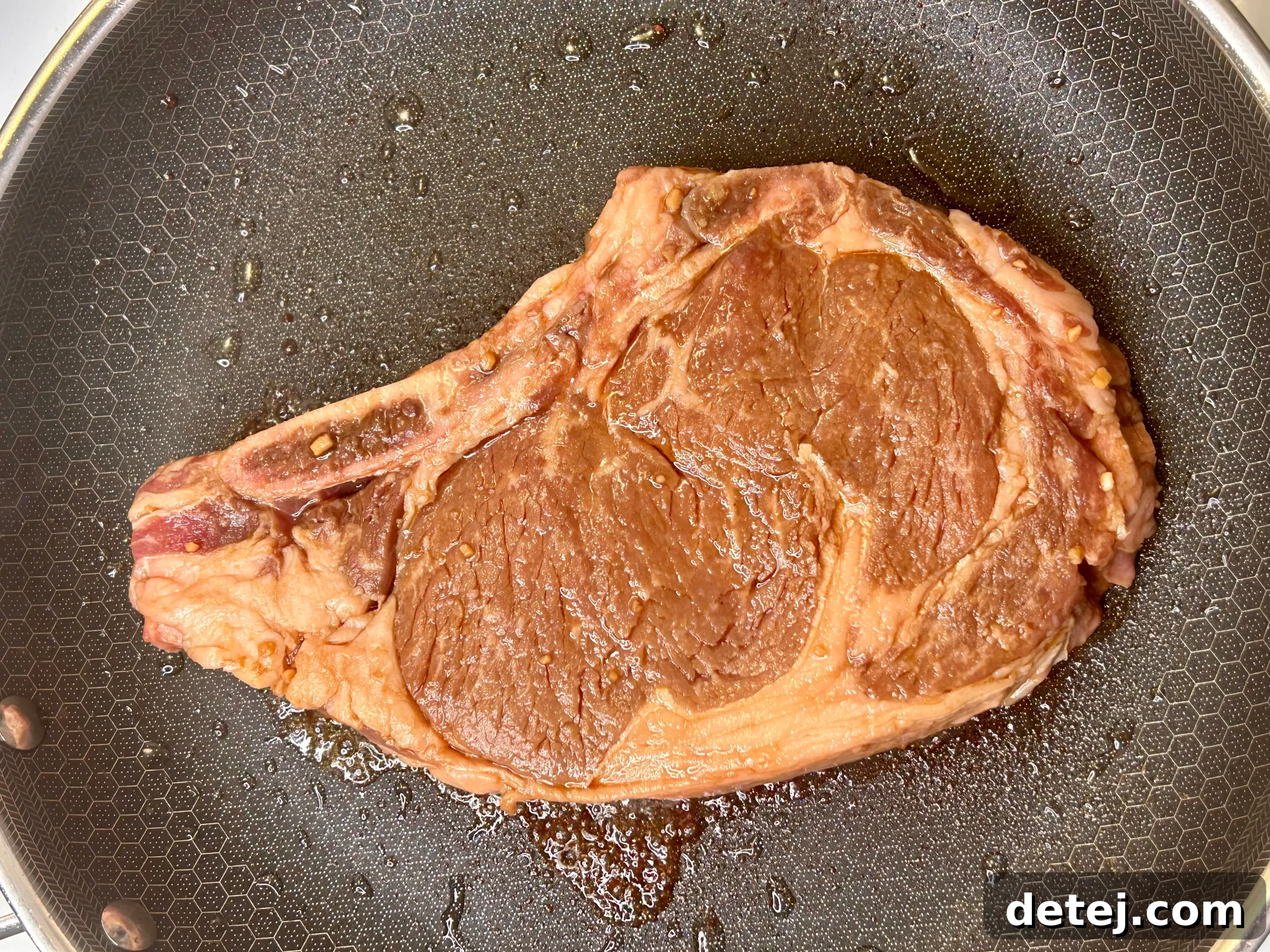 Ribeye steak sizzling on a hot grill