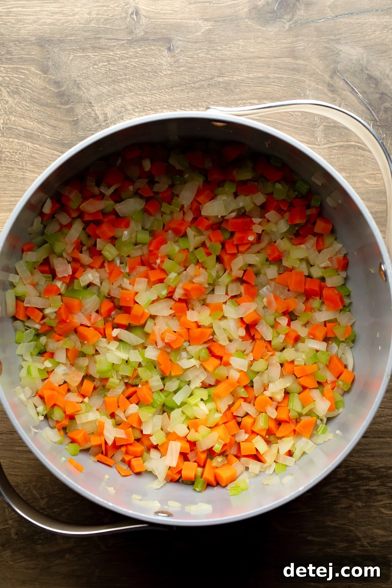 overhead view of cooked vegetables for vegan split pea soup in a large pot.