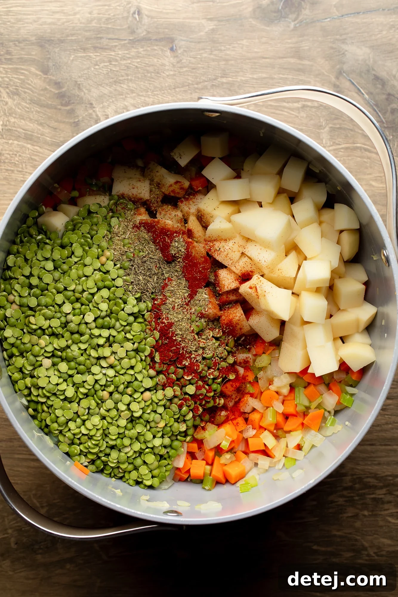 overhead view of the ingredients for vegan split pea soup in a large pot.