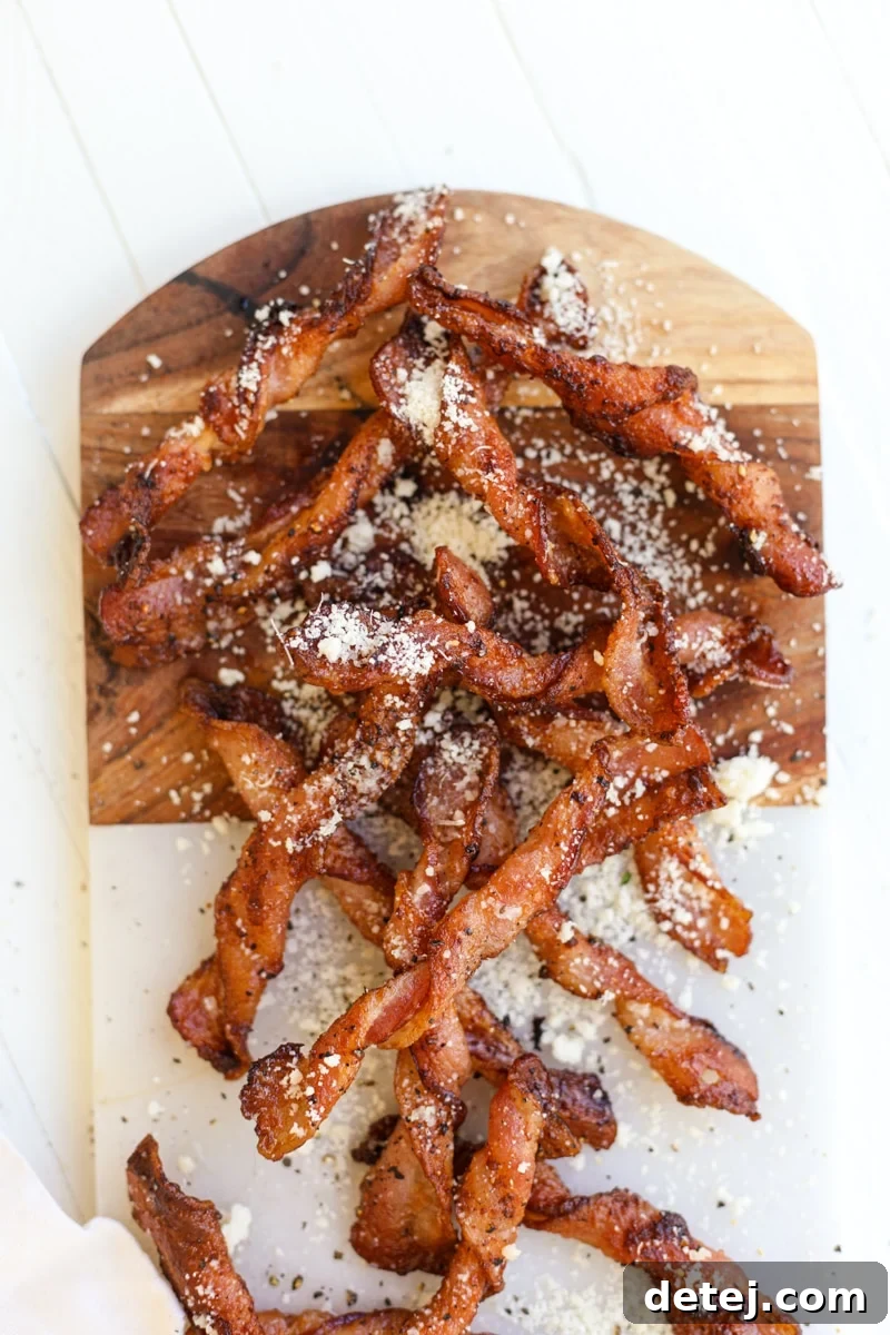 Crispy Parmesan Black Pepper Bacon Twists on a baking sheet, ready to be enjoyed as a keto snack