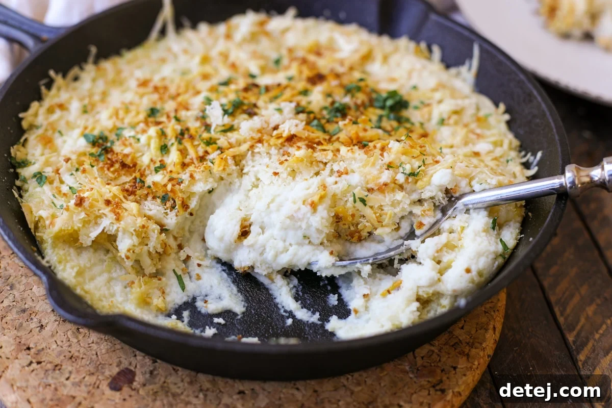 Close-up of creamy Parmesan Mashed Cauliflower Gratin in a skillet