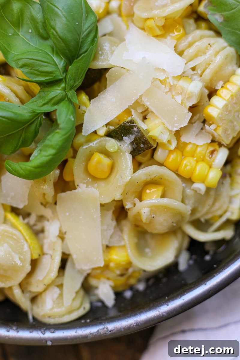 Close-up of fresh zucchini, squash, and corn ready for the summer pasta dish.