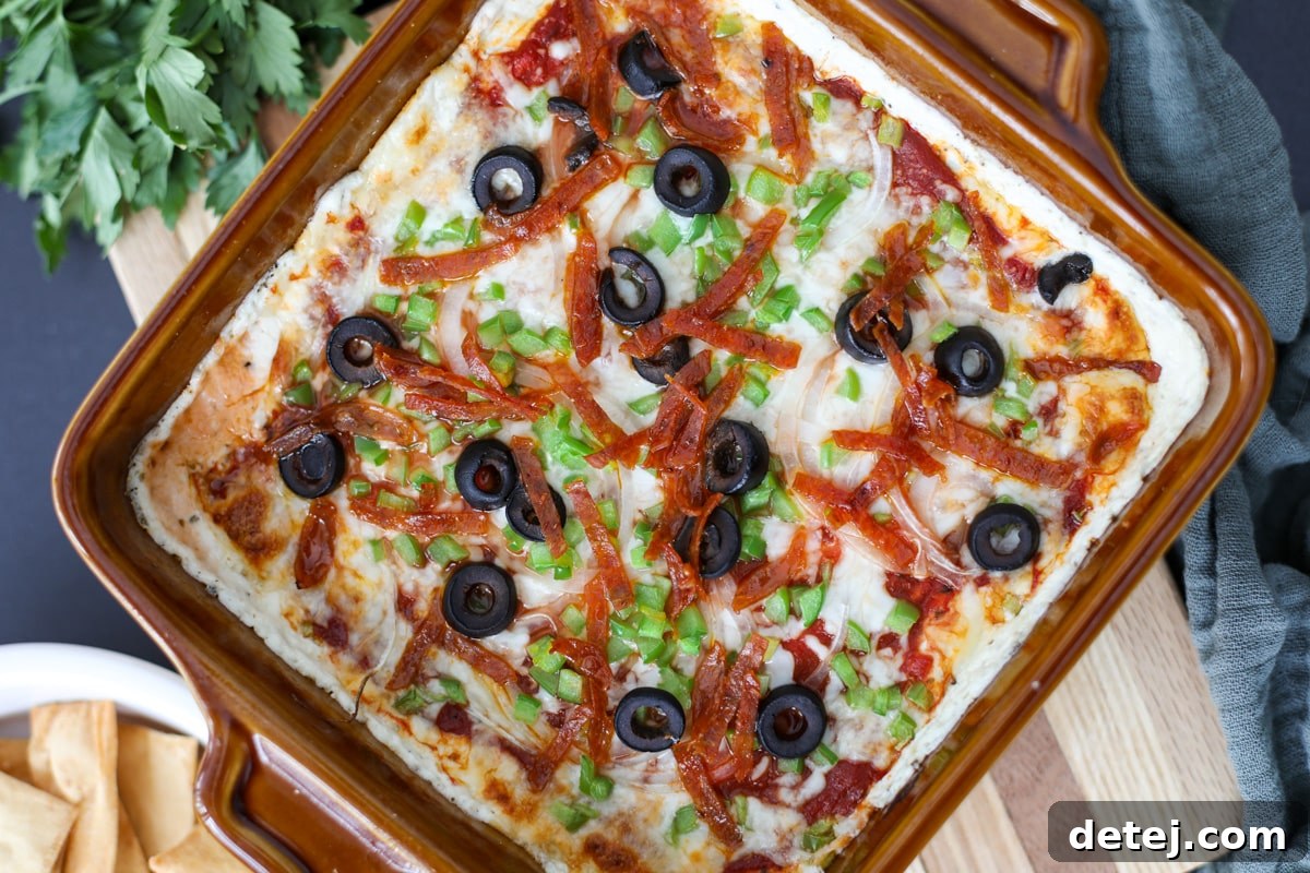 pizza dip with crackers and fresh parsley.