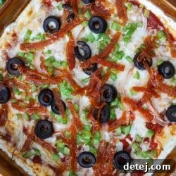 pizza dip served hot with toppings and cheese.