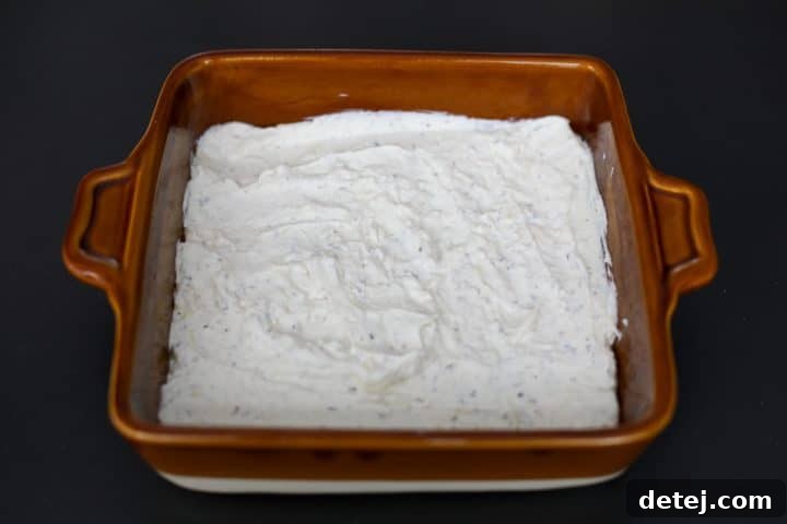 pizza dip added to the baking dish and spread evenly.