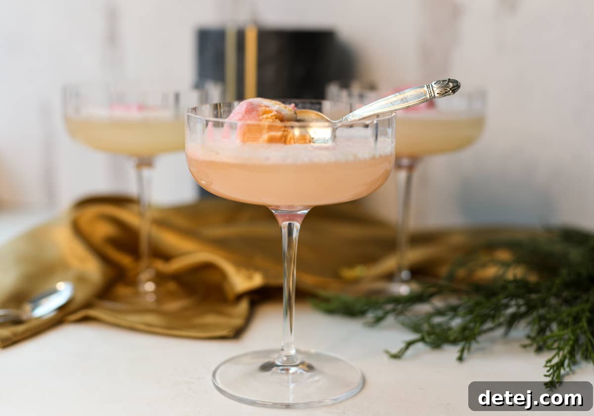 Elegant Rainbow Sorbet Mimosa served in a coupe glass with a mini spoon, ready for a festive brunch or celebration.