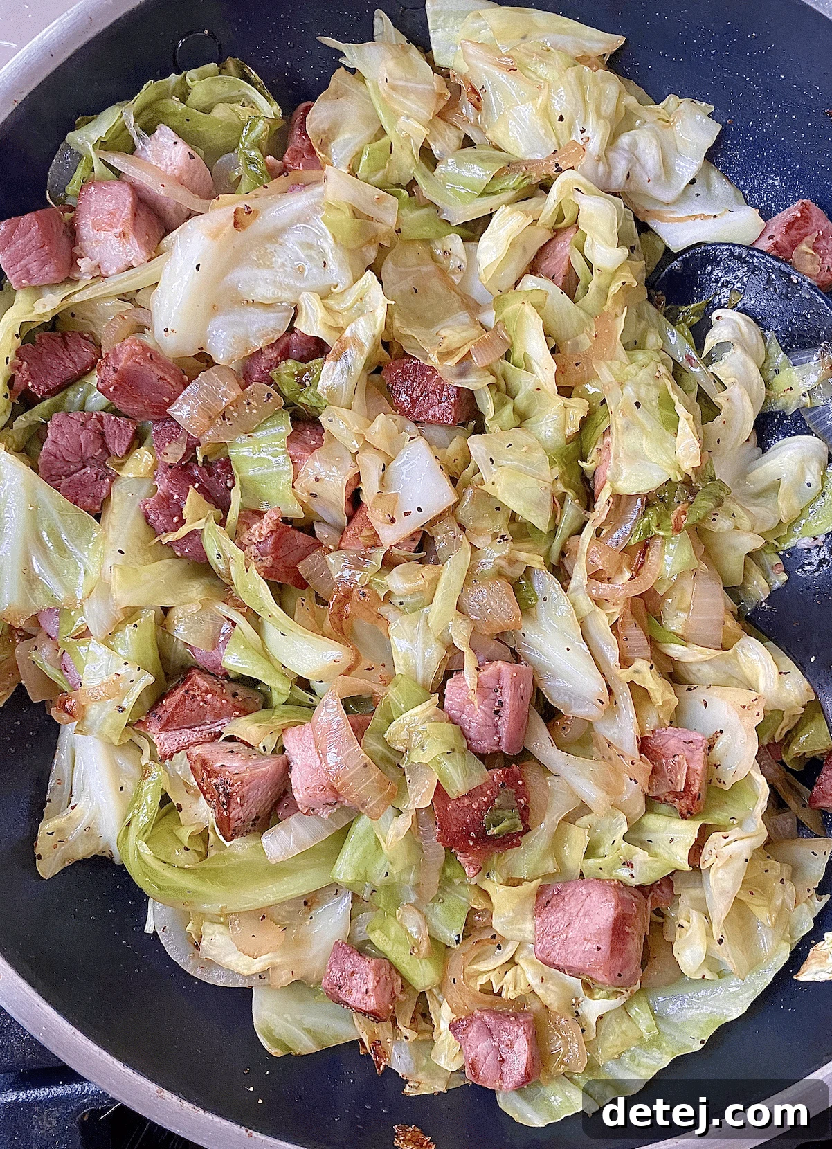 Hearty skillet of Ham and Cabbage, ready to be served