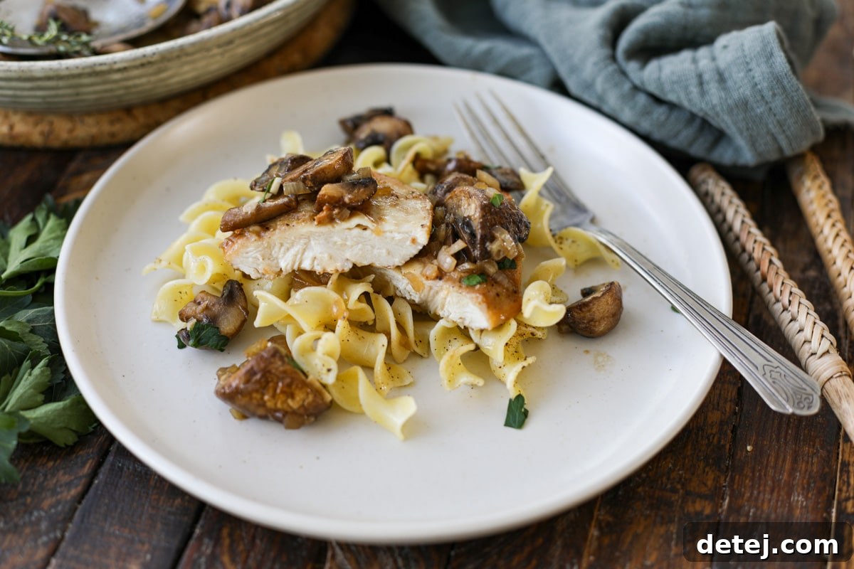 chicken marsala plated over noodles. 