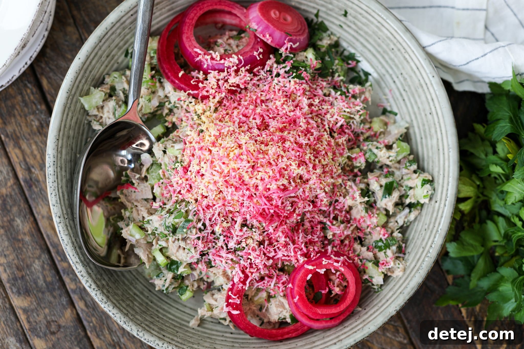 Preparing the ingredients for Tuna Salad with Grated Pickled Egg, showing fresh vegetables and tuna.