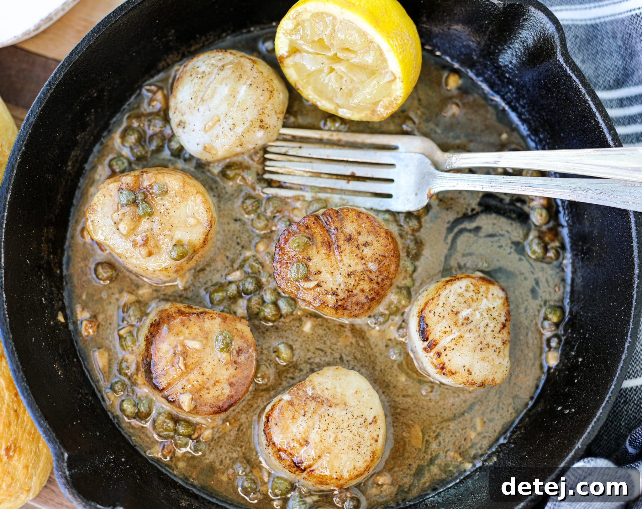 Perfectly Golden Pan Seared Scallops with Lemon Butter Sauce on a plate
