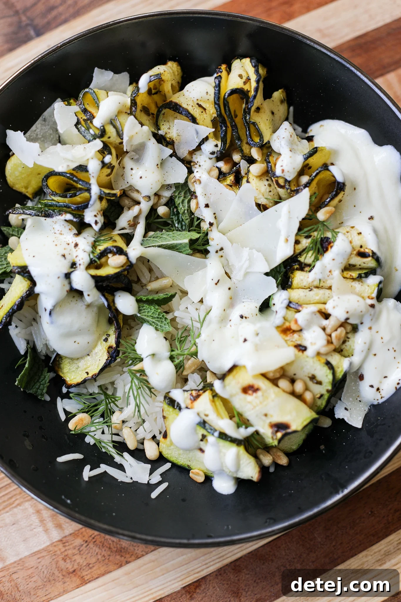 Healthy and delicious grilled zucchini ribbon bowls with fresh herbs and Greek yogurt sauce, perfect for a summer meal.