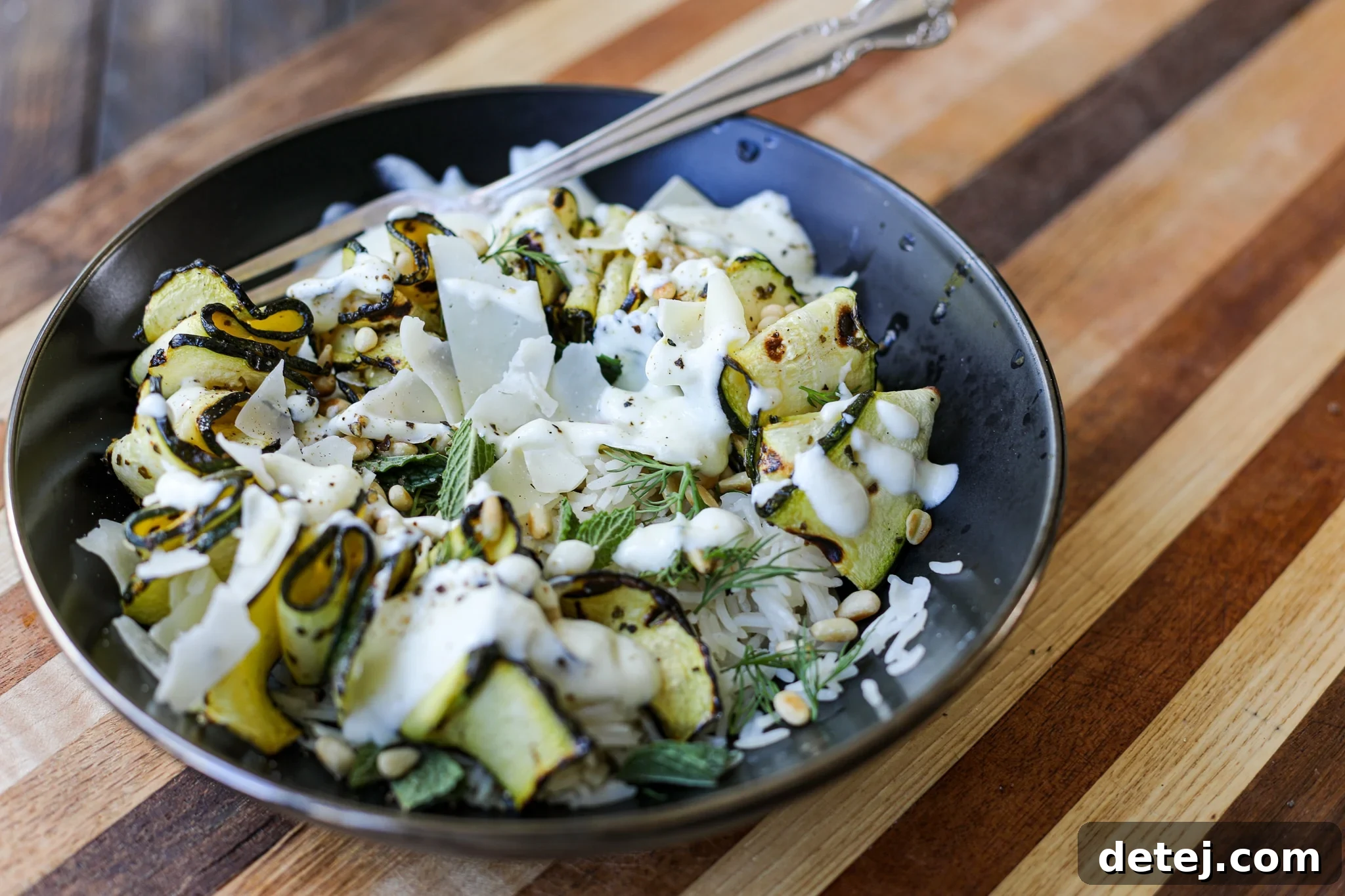 Close-up photo of thin zucchini ribbons perfectly marinated and ready to be grilled.