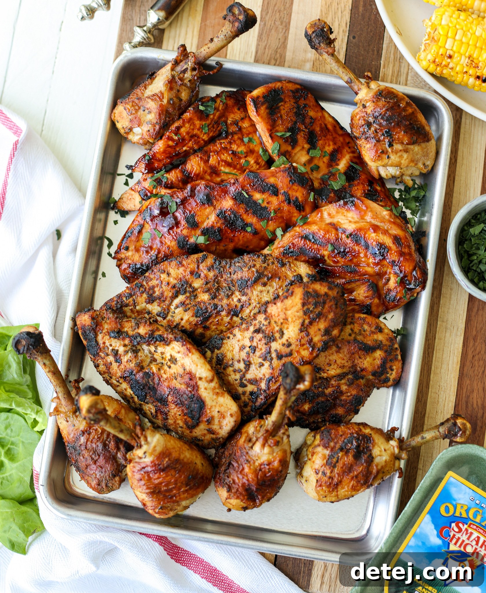 Close-up view of succulent BBQ, Blackened, and Traditional Grilled Chicken pieces on a serving board.