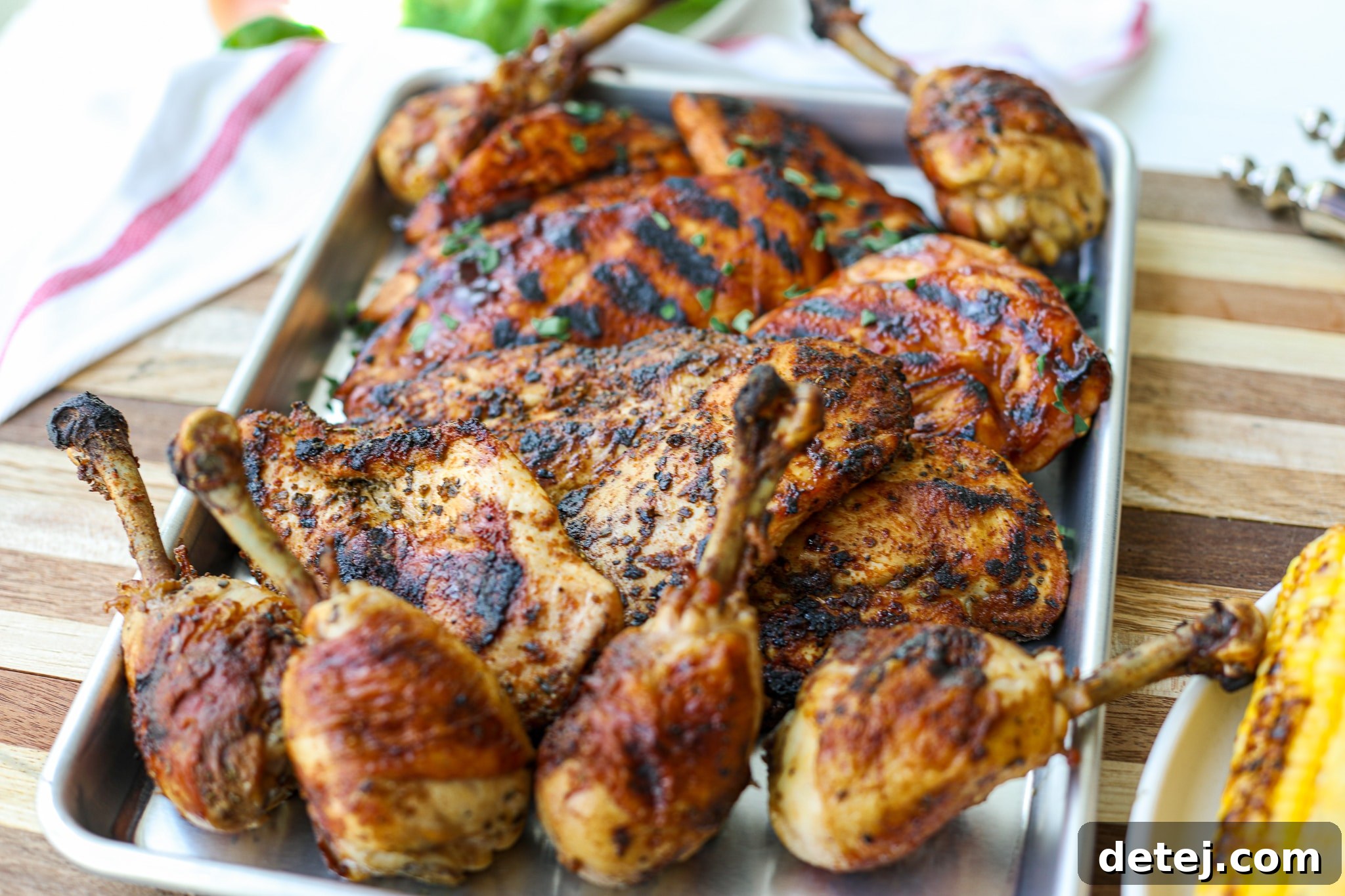 Frenched chicken drumsticks beautifully coated in a savory Italian marinade, ready for the grill.