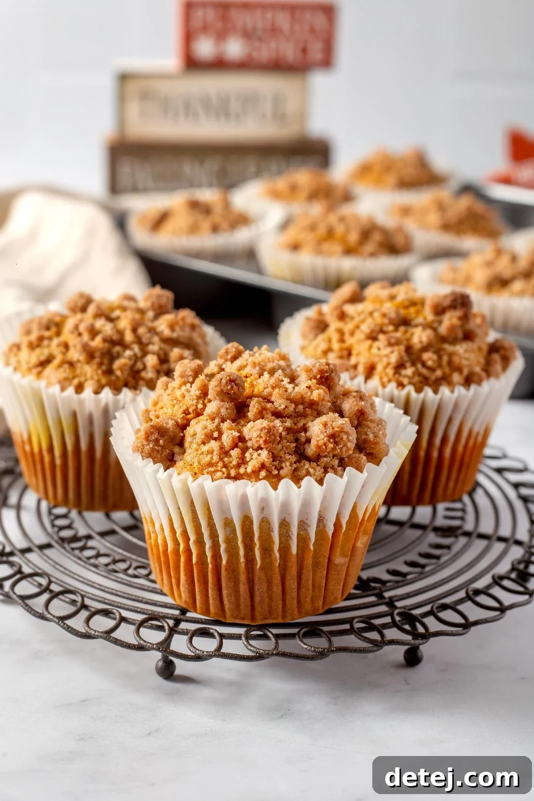Freshly baked pumpkin streusel muffins with a golden crumb topping.