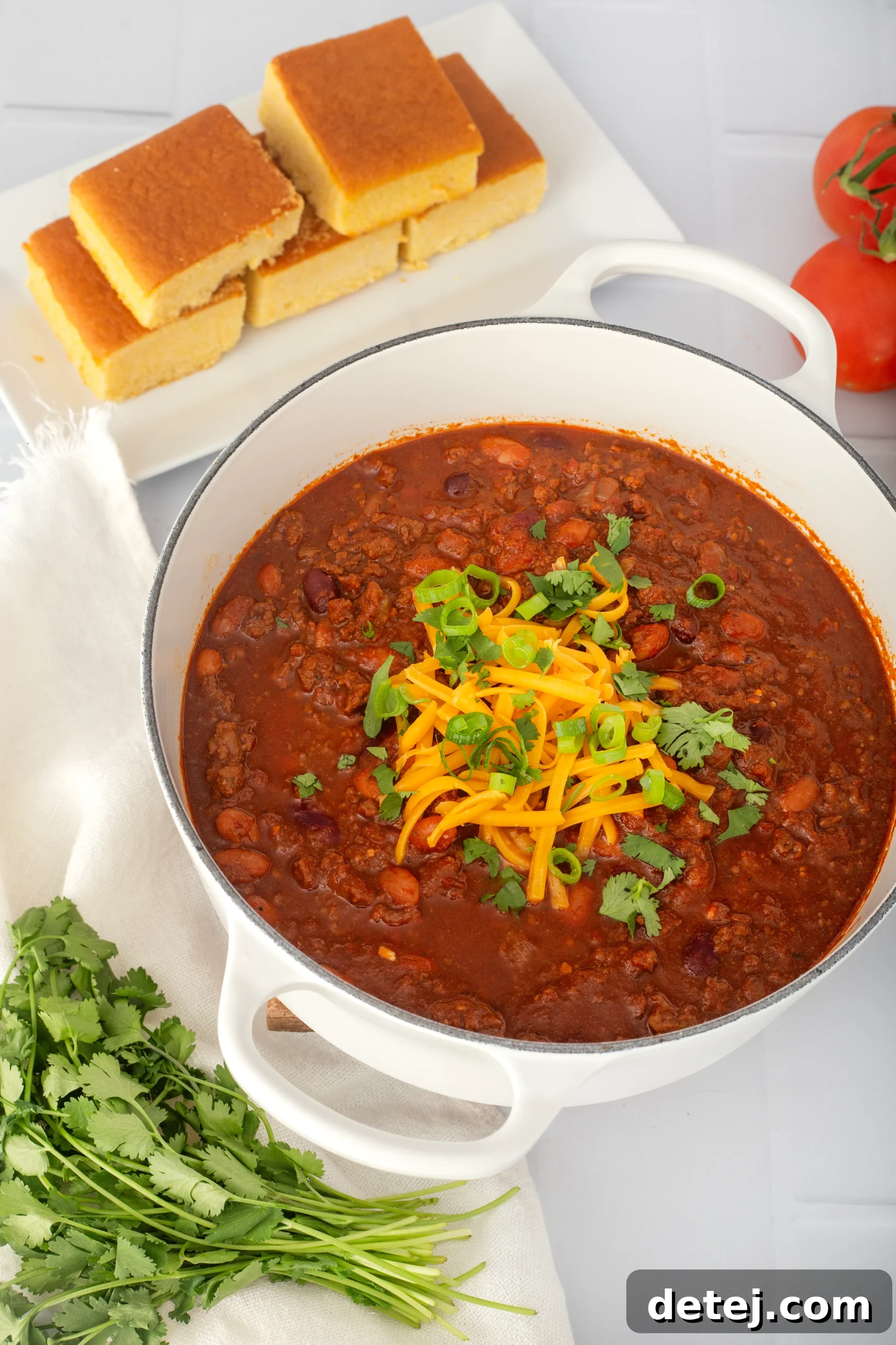 A large pot of homemade stovetop chili simmering with steam rising, promising warmth and comfort.