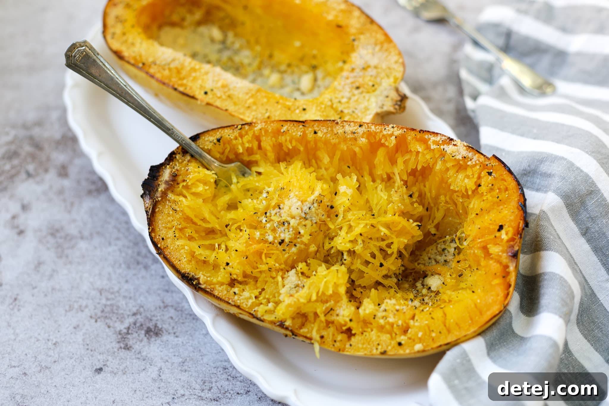 Roasted spaghetti squash strands mixed with Cacio e Pepe sauce, glistening with cheese and pepper.