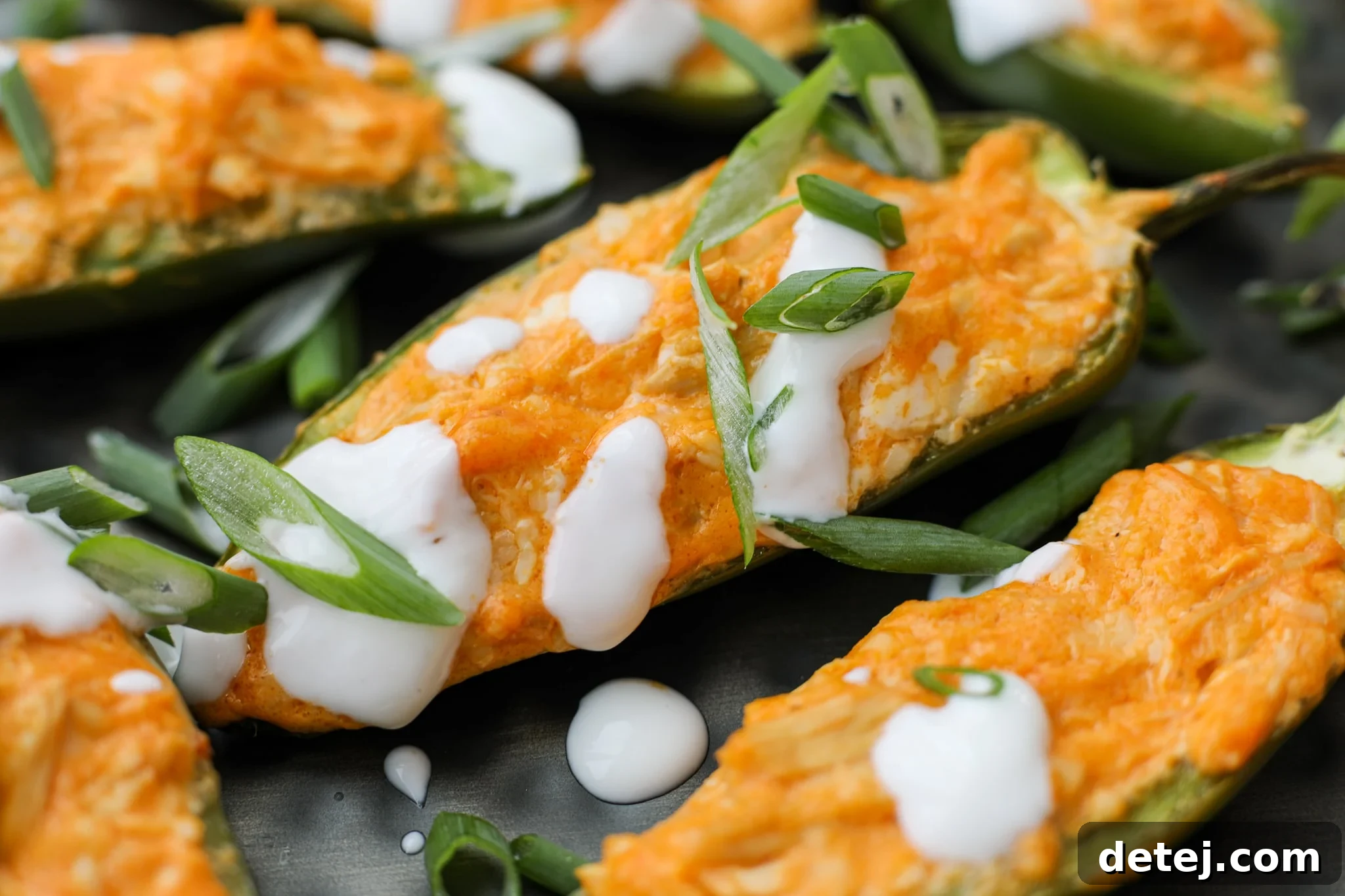 A close-up view of the rich, creamy Buffalo Chicken filling, perfectly mixed and ready to be spooned into fresh jalapeno halves for baking.