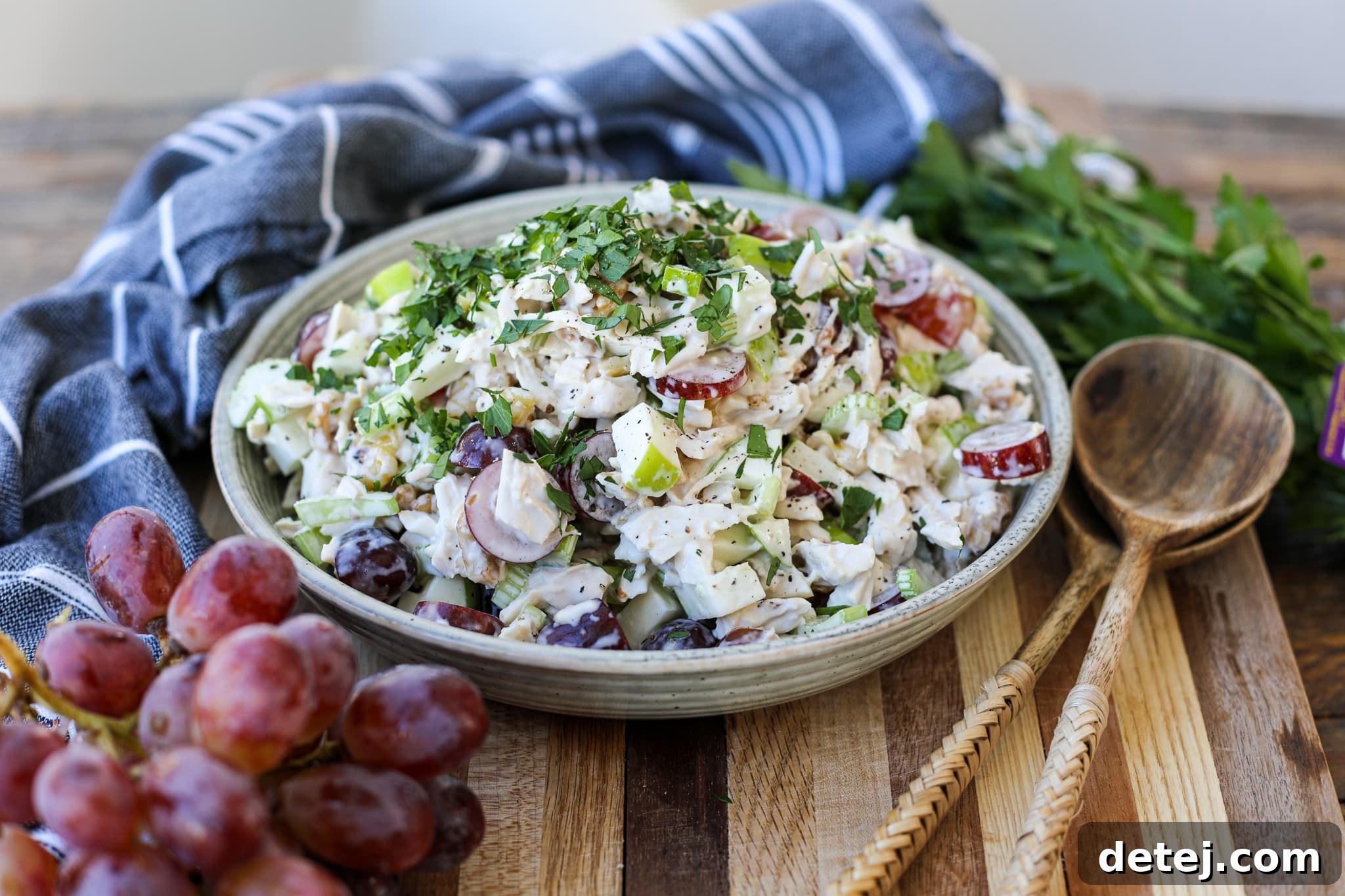 Waldorf Chicken Salad in a bowl, garnished with parsley.